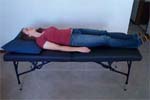 Reiki client lies on massage table.