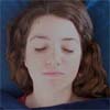 Reiki client's eyes are closed, but her face looks troubled as the Reiki energy reaches old, unresolved emotional problems.