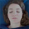 Reiki client's face relaxes and mouth opens slightly as she slips into a meditative state.