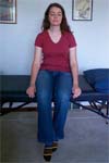 Reiki client sits on the massage table.