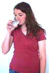 Reiki client drinks from a glass of water.